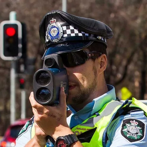 Speeding Fines crest: an officer with a radar gun